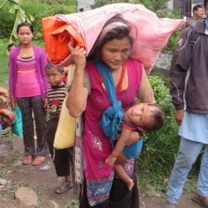 Lady facing a 3 hour walk uphill with baby and 40kg of supplies